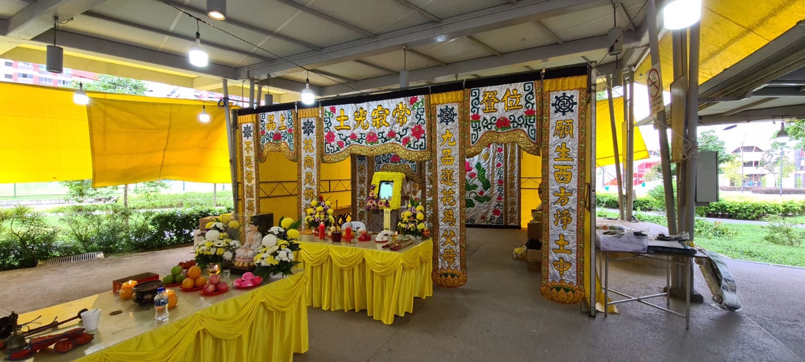 a taoist funeral set up in yellow gold