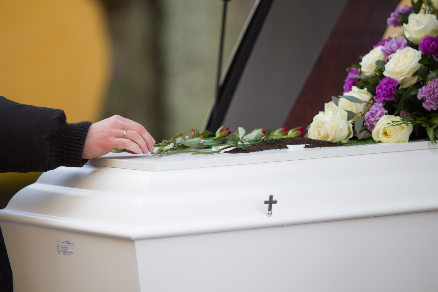 persons hand on a casket